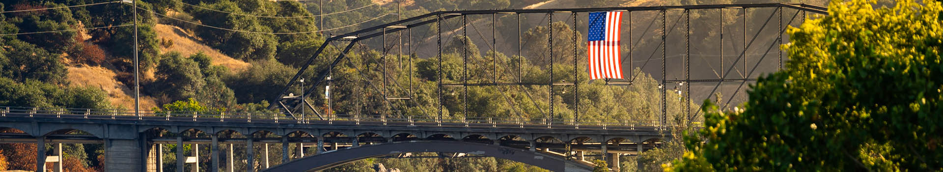 The American Flag hanging over the Truss bridge and Rainbow Bridge