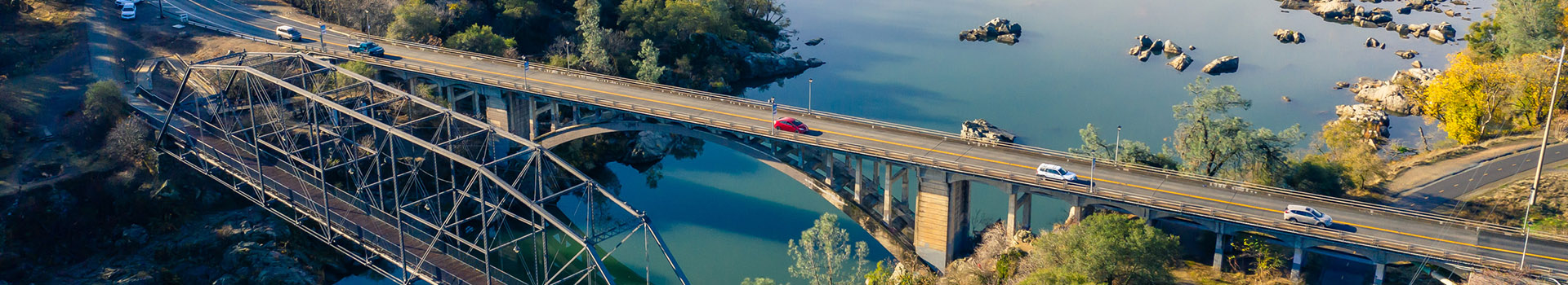 About Banner with photo of rainbow bridge and lake natoma