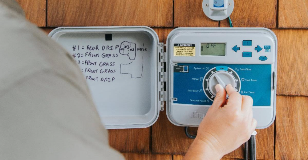 Image of a person adjusting their water system dial. 