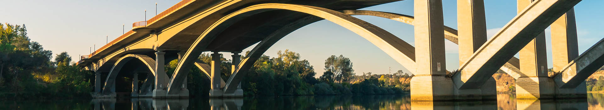 Public Works Banner of Rainbow Bridge at sunset