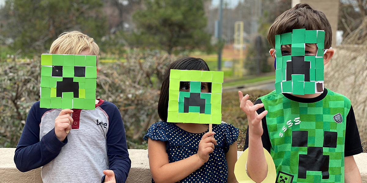 Summer Camp Photo of 3 kids holding their handmade minecraft creeper masks