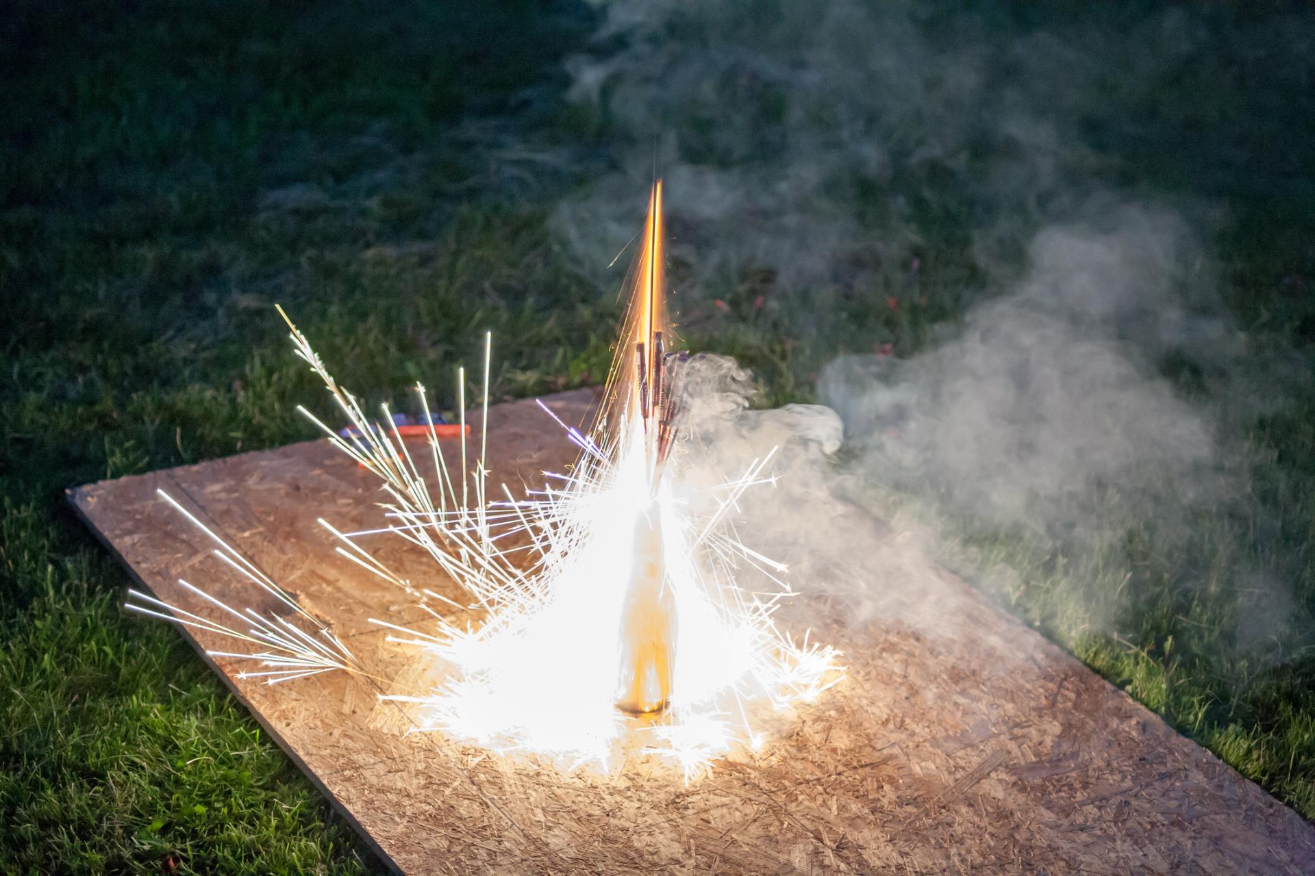 Getty Image of a close-up of lit fireworks on a wooden board