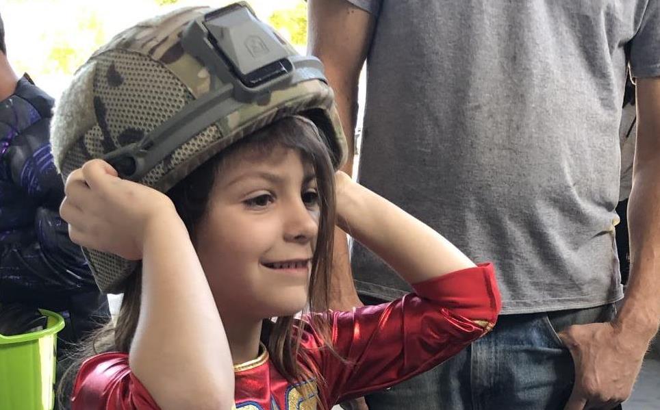 Girl in Wonderwoman Costume tries on SWAT helmet