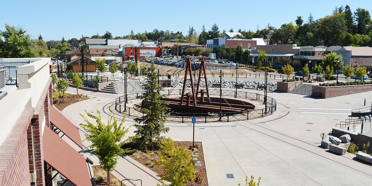 historic district shot overlooking the railroad track with trees and businesses in the background on a clear sunny day