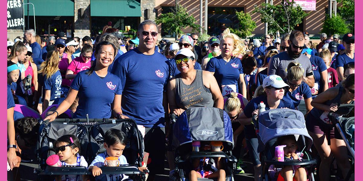 Love My Mom Start Line Women and men with children in strollers posing for a picture