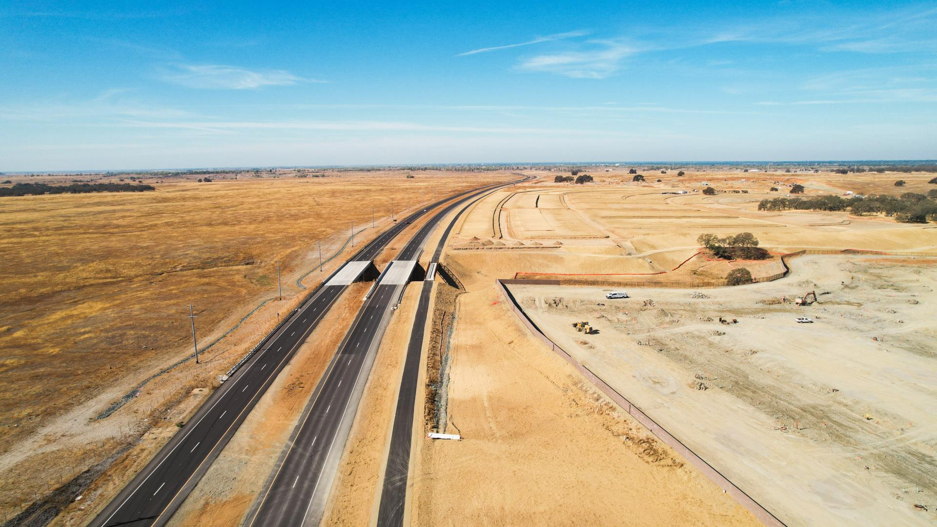 Image of four lane road and bike trail from the air of the SE conector project