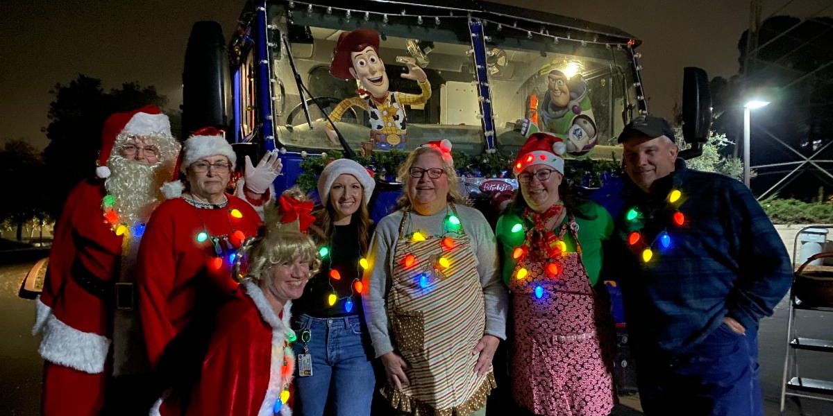 city staff in font of a holiday decorated fire truck