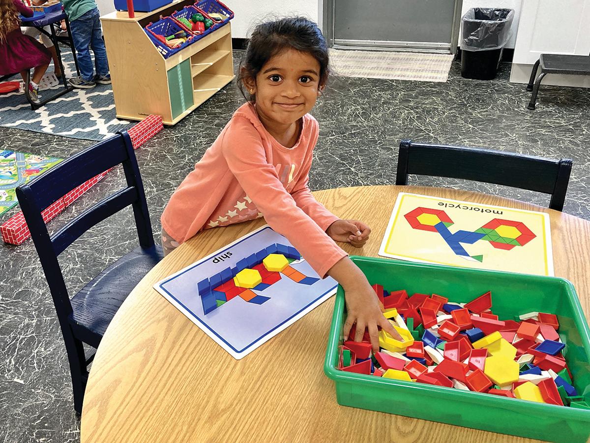 Child at preschool playing with legos