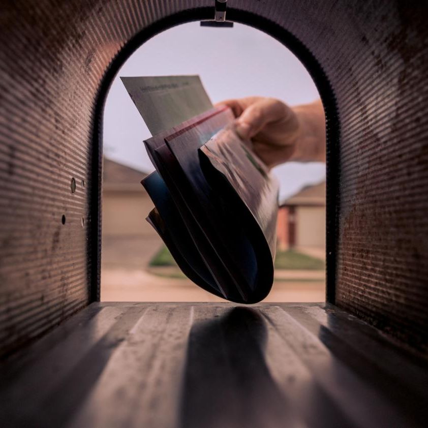 Hand reaching into a mailbox