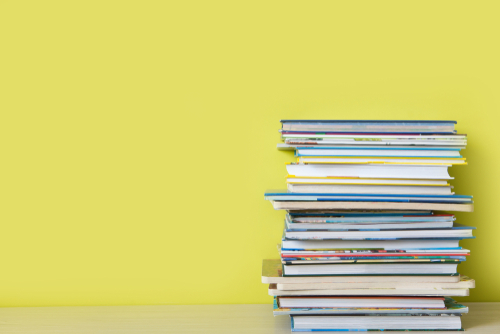 Childrens books lie on a bookshelf